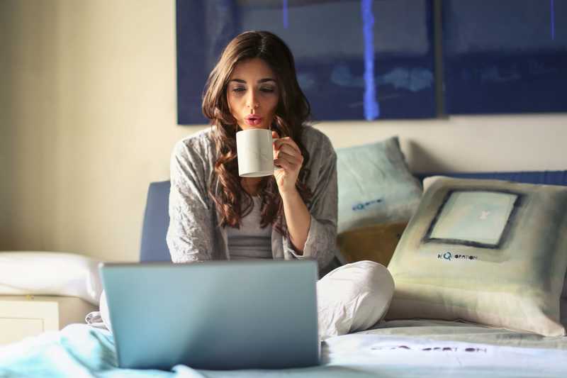 Woman with laptop and mug