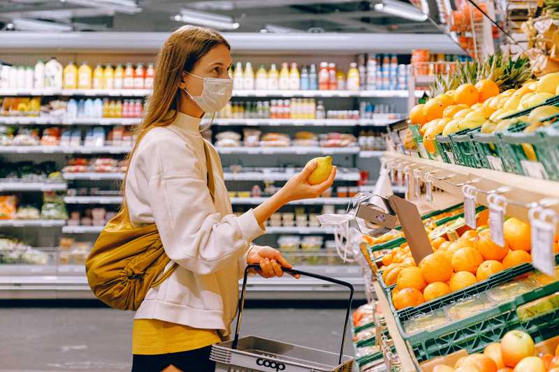 Woman in mask with lemon